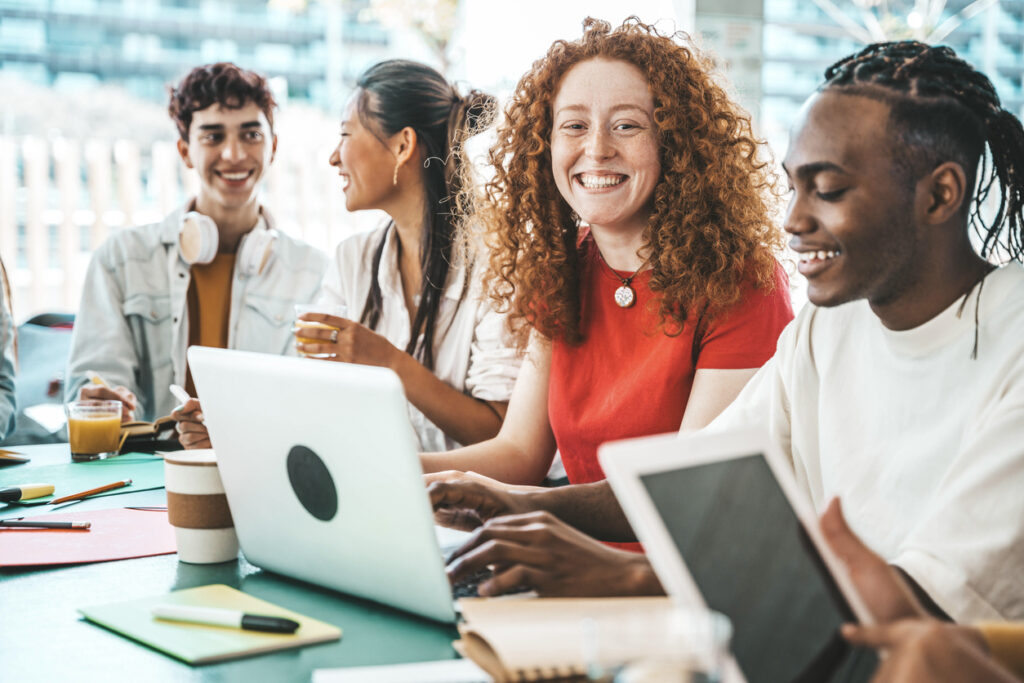 college students sitting together smiling